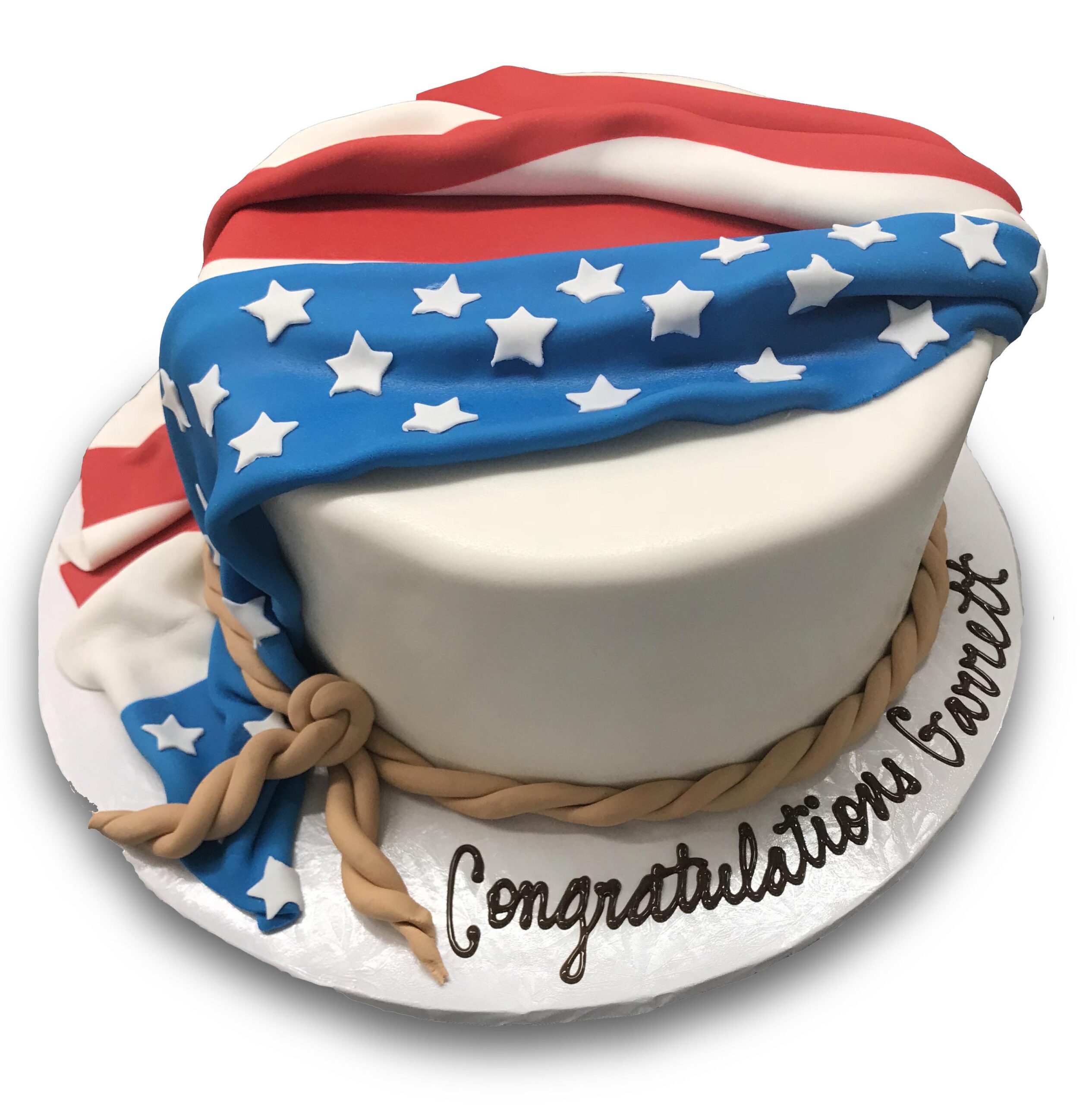 Fondant covered cake with fondant flag and rope 