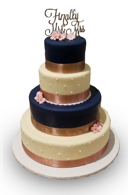 Four tiered navy and ivory fondant covered wedding cake 