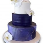 Three tier fondant covered cake with gumpaste orchids