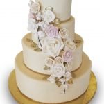 Fondant covered four tier wedding cake with gumpaste flowers