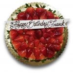 Glazed strawberry cheesecake with a fondant birthday banner