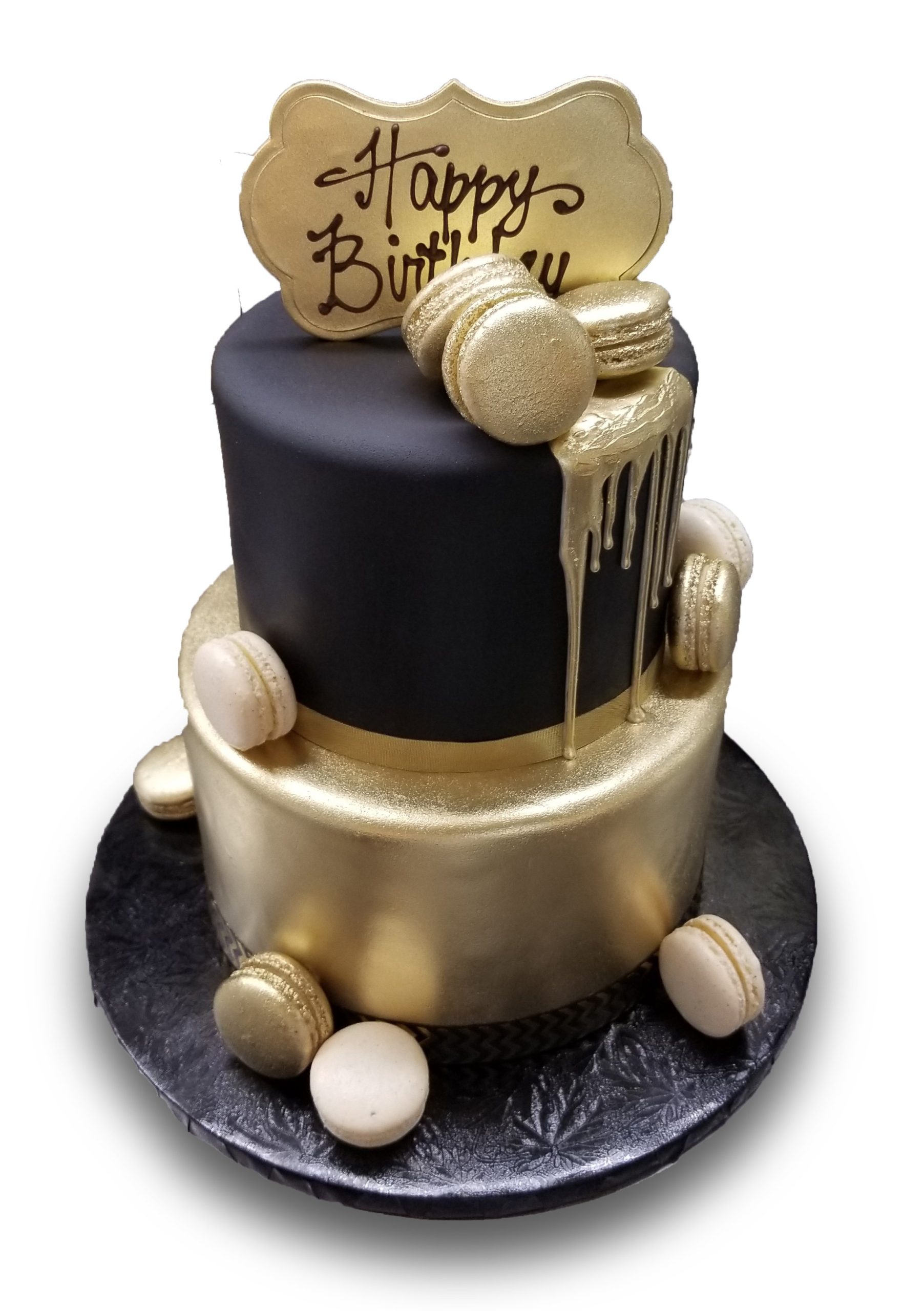 AB019. Two tiered black and gold fondant covered birthday cake with dripping gold chocolate and white and gold macarons