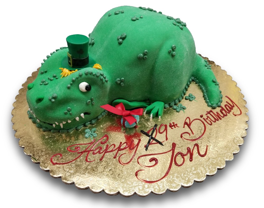 Tyrannosaurus Rex shaped cake covered in fondant