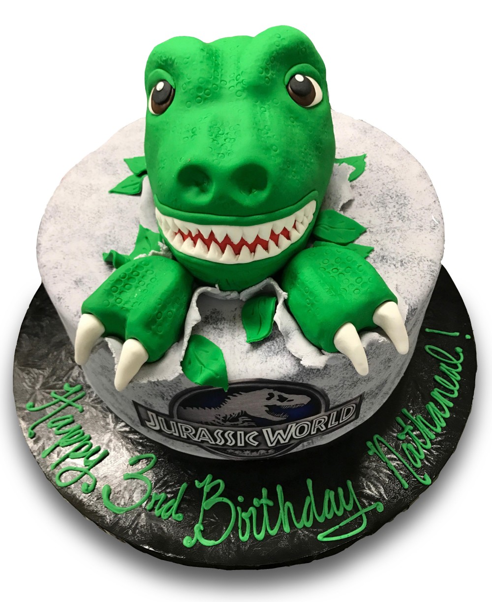Fondant covered cake with fondant dinosaur head and jurassic park scan