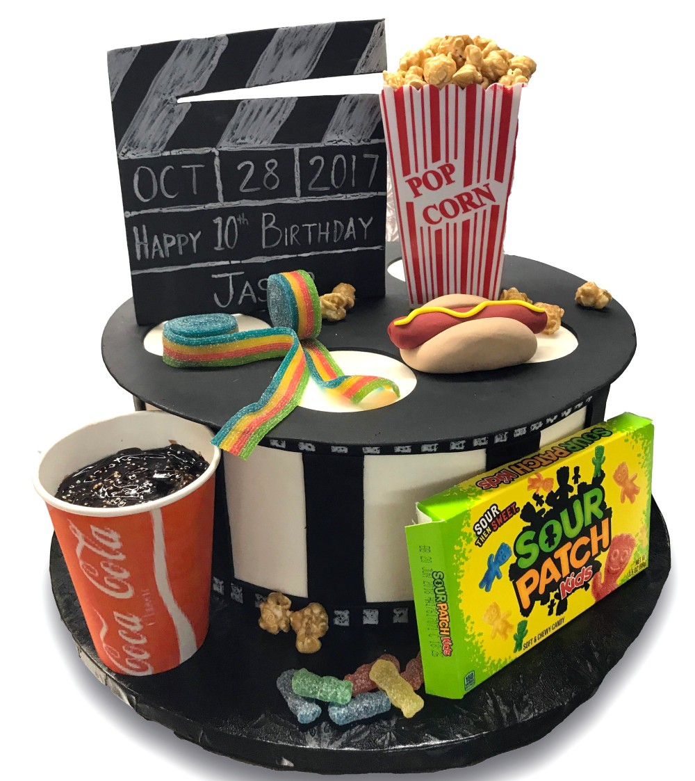 Fondant covered movie themed birthday cake with candy and popcorn