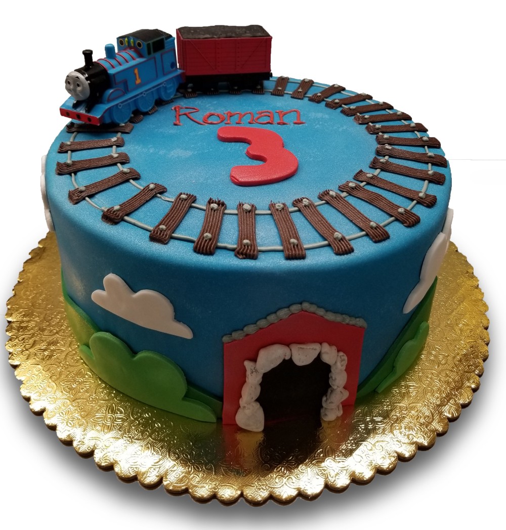 Fondant covered Thomas the Train cake with buttercream tracks and fondant clouds and hills