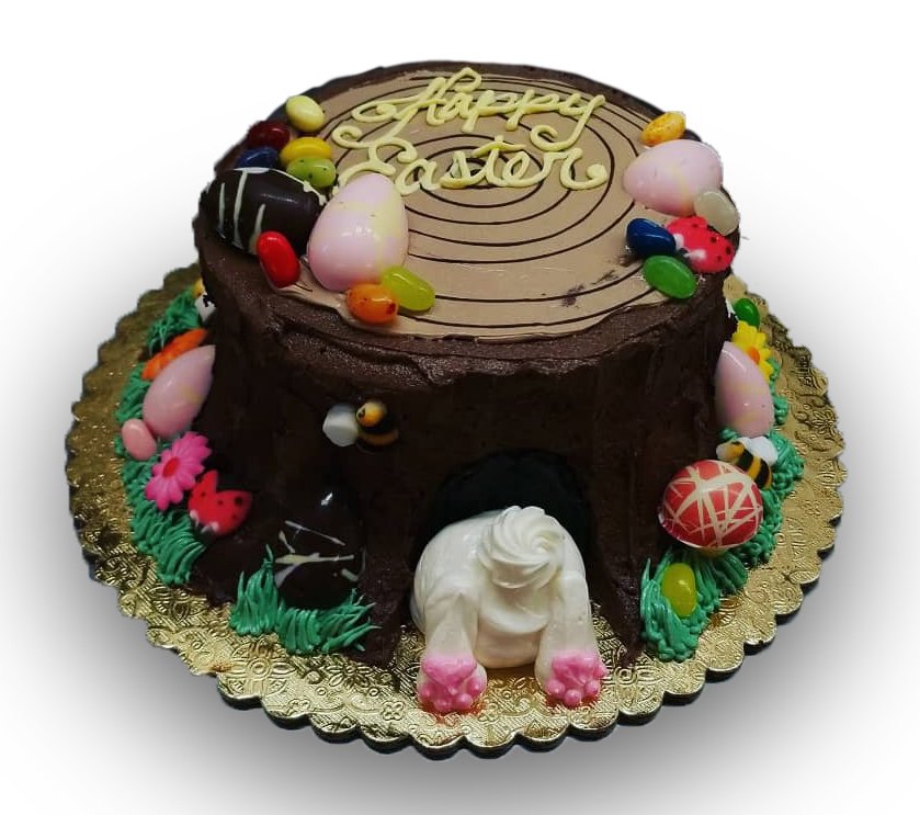 easter bunny hiding under a tree stump cake