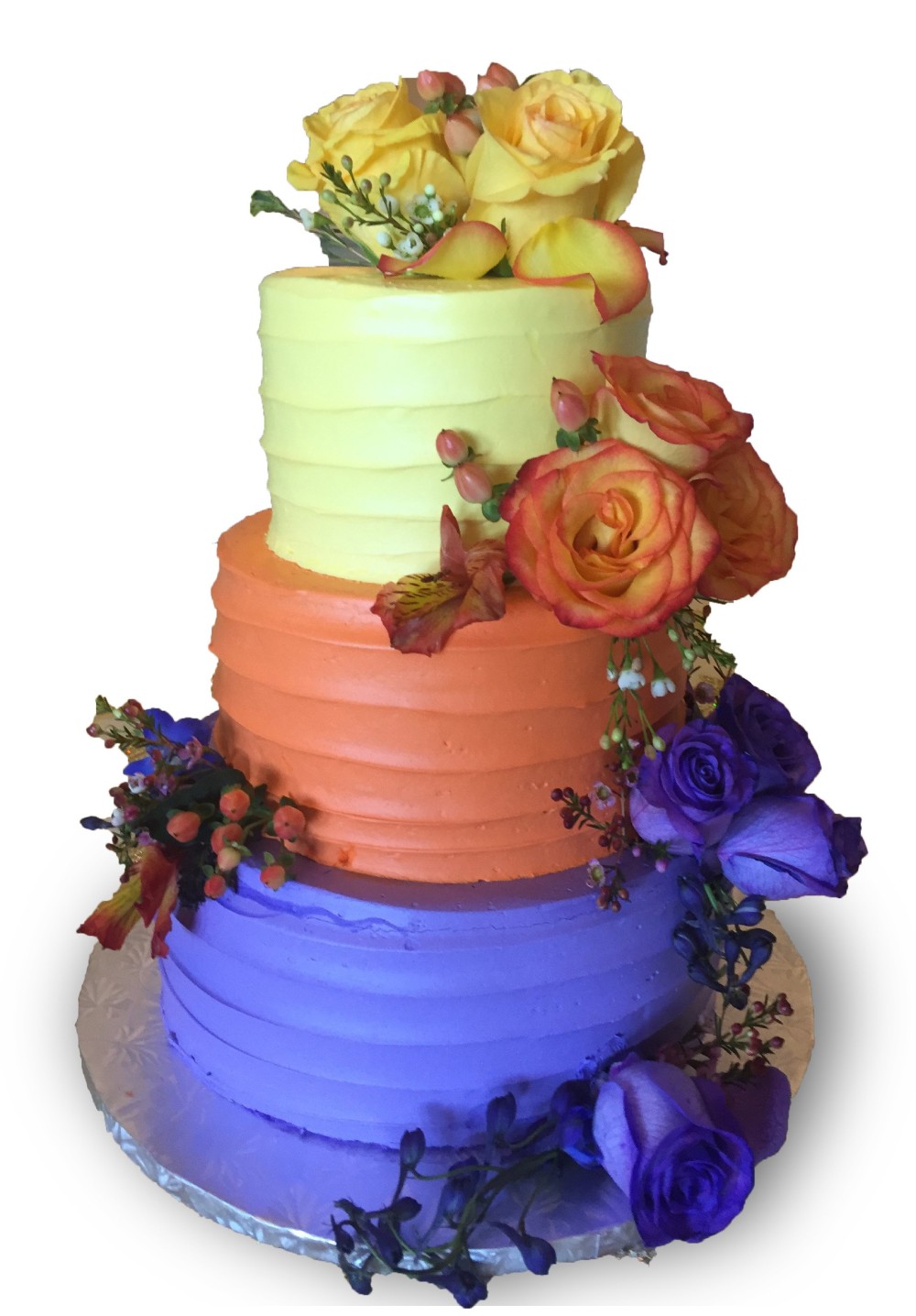 Colorful three tier homespun cake with fresh roses 