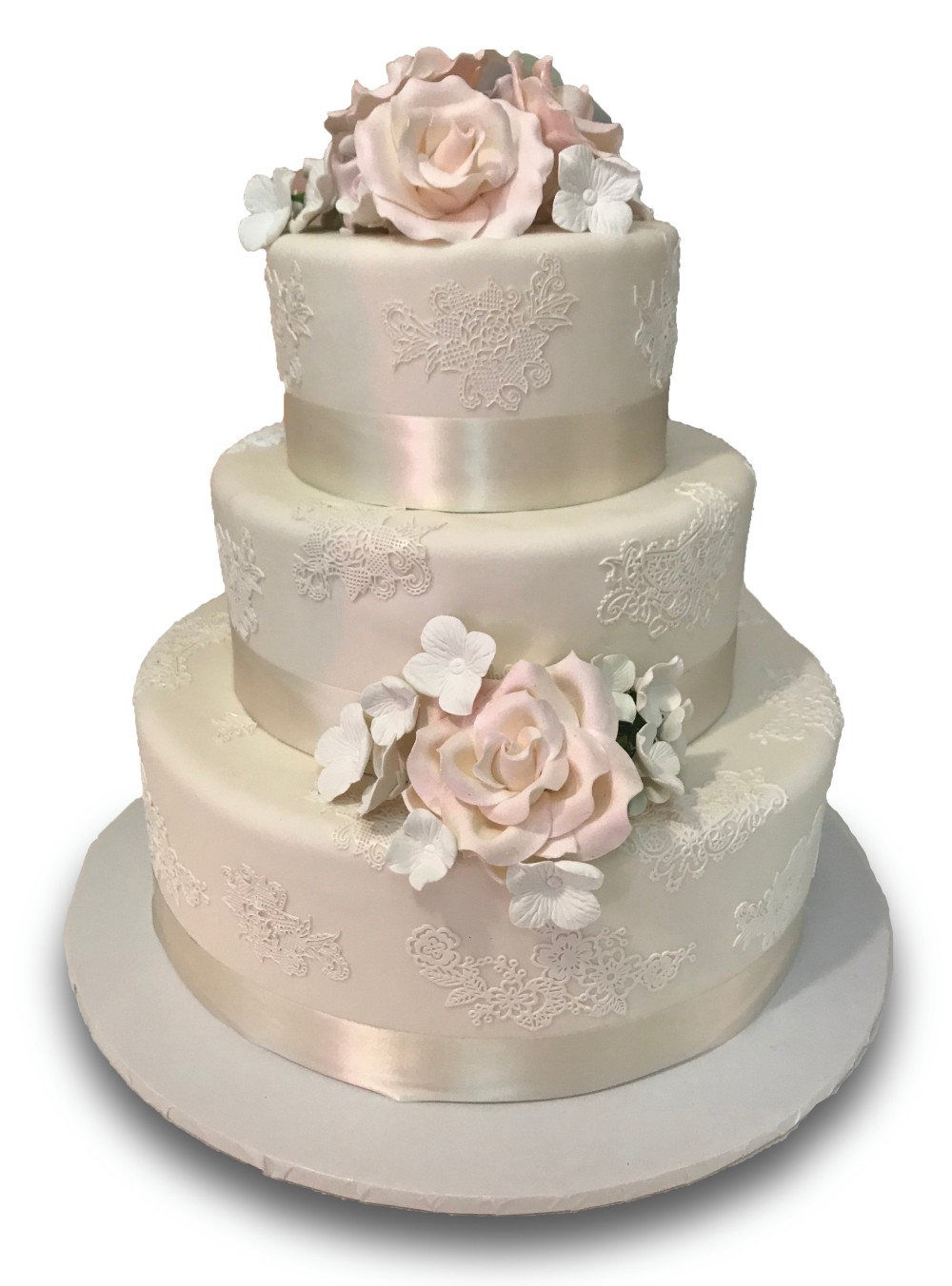 Three tiered fondant covered cake with ivory ribbon, edible lace and gumpaste flowers 