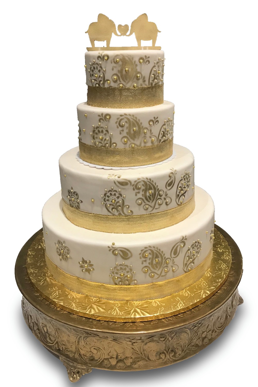 Fondant covered cake with gold paisley pattern and gold elephant topper 